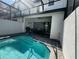 Enjoy the in-ground pool with a screened lanai and outdoor seating area at 306 Captiva Dr, Davenport, FL 33896