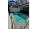 Inviting in-ground pool under a screened enclosure, perfect for cooling off on hot days at 306 Captiva Dr, Davenport, FL 33896