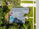 Aerial view of the home showing roof, landscaping, lawn, and a screened-in pool at 315 Lake Rd, Lake Mary, FL 32746