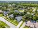 Drone shot showing a lovely neighborhood with mature trees and multiple houses with swimming pools at 315 Lake Rd, Lake Mary, FL 32746