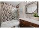 Updated bathroom with stylish shower, patterned tiles, vanity with marble countertop and dark wood cabinets at 315 Lake Rd, Lake Mary, FL 32746