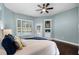 Comfortable bedroom with light blue walls, a window view, and a ceiling fan at 315 Lake Rd, Lake Mary, FL 32746