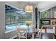 Dining area featuring a table with chairs, a decorative light fixture, and a view of the pool at 315 Lake Rd, Lake Mary, FL 32746