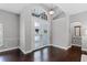 Bright foyer featuring hardwood floors, a statement door with decorative windows, and elegant trim at 315 Lake Rd, Lake Mary, FL 32746