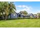Beautiful home with a lush green lawn and mature palm trees adding to the curb appeal at 315 Lake Rd, Lake Mary, FL 32746