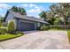 Close up of a home's two-car garage with ample driveway space, surrounded by a well-manicured lawn at 315 Lake Rd, Lake Mary, FL 32746