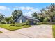 Home featuring a two-car garage and ample driveway space, surrounded by a well-manicured lawn and landscaping at 315 Lake Rd, Lake Mary, FL 32746