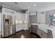 Bright kitchen with white cabinets, stainless steel refrigerator and kitchen island at 315 Lake Rd, Lake Mary, FL 32746