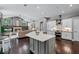 Modern kitchen with a view into the living room with fireplace and dining area, offering a spacious and open design at 315 Lake Rd, Lake Mary, FL 32746