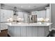 Bright kitchen features white cabinets, an island with countertop, and stainless steel appliances at 315 Lake Rd, Lake Mary, FL 32746