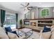 Bright living room with access to the pool area, showcasing a cozy fireplace and comfortable seating arrangement at 315 Lake Rd, Lake Mary, FL 32746