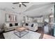 Open-concept living room featuring elegant decor, modern furniture, and seamless transition to the kitchen and dining areas at 315 Lake Rd, Lake Mary, FL 32746