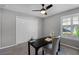 Home office with a ceiling fan, a black desk, a chair, and a window with plantation shutters at 315 Lake Rd, Lake Mary, FL 32746