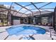 Inviting pool surrounded by a screened enclosure and lush landscaping with the home in the background at 315 Lake Rd, Lake Mary, FL 32746