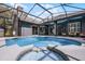 Inviting pool and hot tub surrounded by a screened enclosure and lush landscaping with the home in the background at 315 Lake Rd, Lake Mary, FL 32746