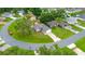 Aerial view of a property in the middle of a circular street with some trees at 339 Colony Ct, Kissimmee, FL 34758
