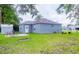 Spacious backyard featuring green grass, patio, and outdoor seating area at 339 Colony Ct, Kissimmee, FL 34758