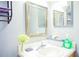 Bright bathroom featuring a vanity with a sink, mirror, and fresh decor accents at 339 Colony Ct, Kissimmee, FL 34758