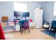Functional bedroom space with desk, monitors, and storage, creating an organized workspace at 339 Colony Ct, Kissimmee, FL 34758