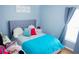 Relaxing bedroom with a bed featuring a plush headboard, soft bedding, and calming blue decor at 339 Colony Ct, Kissimmee, FL 34758