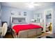 Cozy bedroom with stylish bed, framed art, and ensuite bathroom at 339 Colony Ct, Kissimmee, FL 34758