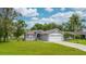 Charming single-story home featuring a well-maintained lawn, blue siding, and two-car garage at 339 Colony Ct, Kissimmee, FL 34758