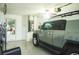 Spacious garage featuring epoxy flooring, ample storage space, and a newer car in the residence at 339 Colony Ct, Kissimmee, FL 34758