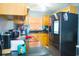 A modern kitchen showcasing stainless steel appliances, wood cabinets, and sleek countertops at 339 Colony Ct, Kissimmee, FL 34758