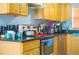 Kitchen with black countertops, wooden cabinets, stainless steel appliances, and recessed lighting at 339 Colony Ct, Kissimmee, FL 34758