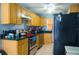 Kitchen with black countertops, wooden cabinets, stainless steel appliances, and recessed lighting at 339 Colony Ct, Kissimmee, FL 34758