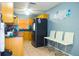 Efficient kitchen featuring wood cabinets, tile floor, and modern appliances at 339 Colony Ct, Kissimmee, FL 34758