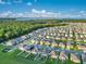 An aerial view of the community, showcasing the neighborhood and nearby lake and woods at 3408 Curlew Ave, Leesburg, FL 34748