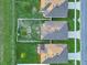 An aerial view showing neighboring houses, lawn, and landscaping on a sunny day at 3408 Curlew Ave, Leesburg, FL 34748