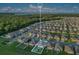 An aerial view of the neighborhood, showcasing the property's location near a lake and wooded area at 3408 Curlew Ave, Leesburg, FL 34748