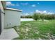 This fenced backyard featuring a green lawn at 3408 Curlew Ave, Leesburg, FL 34748