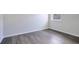 This is a cozy bedroom featuring durable flooring, and a bright window at 3408 Curlew Ave, Leesburg, FL 34748