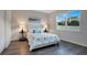 Bright bedroom with large window, hardwood floors, and white furnishings at 3408 Curlew Ave, Leesburg, FL 34748