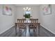 Bright dining area with chandelier and natural light from the backyard window at 3408 Curlew Ave, Leesburg, FL 34748