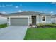 Charming single-story home featuring a well-maintained lawn and a two-car garage at 3408 Curlew Ave, Leesburg, FL 34748