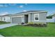 A cozy single-story house showcases a green lawn and an attached two-car garage at 3408 Curlew Ave, Leesburg, FL 34748