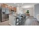 Kitchen with stainless steel appliances, breakfast bar with stools, and adjacent dining area at 3408 Curlew Ave, Leesburg, FL 34748