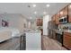 Modern kitchen featuring stainless steel appliances, a granite island, and hardwood floors at 3408 Curlew Ave, Leesburg, FL 34748