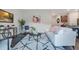 A sleek living room with hardwood floors and an adjacent dining area and kitchen at 3408 Curlew Ave, Leesburg, FL 34748