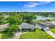 Desirable lakefront property with lush surroundings, solar panels, a well-manicured yard, and mature trees at 3417 Pershing Ave, Orlando, FL 32812