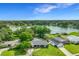 Expansive aerial view highlighting the home's manicured lawn and nearby lake at 3417 Pershing Ave, Orlando, FL 32812