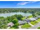 Breathtaking aerial view of the property with a lake view, surrounded by lush landscaping and mature trees at 3417 Pershing Ave, Orlando, FL 32812