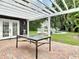 Outdoor patio with a pergola, table, brick flooring, and view of the pool at 3417 Pershing Ave, Orlando, FL 32812