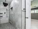 Luxurious bathroom with tiled walk-in shower and view of the bedroom at 3417 Pershing Ave, Orlando, FL 32812