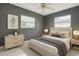 Cozy bedroom featuring ample natural light, neutral color scheme, comfortable bedding, and tile flooring at 3417 Pershing Ave, Orlando, FL 32812