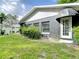 Exterior view of home with a pergola, landscaping, and awning at 3417 Pershing Ave, Orlando, FL 32812